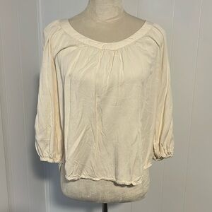 Cream 3/4 sleeve with detail on the arms